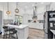 Modern kitchen featuring a breakfast bar, stainless steel appliances, white cabinetry, and pendant lighting at 500 Canborough Lane, Murrells Inlet, SC 29576