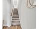 Carpeted stairway with wood trim and lots of natural light at 500 Canborough Lane, Murrells Inlet, SC 29576