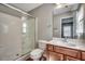 Bright bathroom featuring a stand-up shower with glass doors and vanity with cabinets at 504 Lake Shore Dr., Surfside Beach, SC 29575