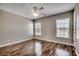 A serene bedroom with natural light from two windows and wood-look floors at 504 Lake Shore Dr., Surfside Beach, SC 29575