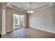 Bright dining area with tile flooring, chandelier, and a sliding glass door at 504 Lake Shore Dr., Surfside Beach, SC 29575