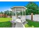 Charming gazebo surrounded by lush greenery on a sunny day at 504 Lake Shore Dr., Surfside Beach, SC 29575