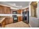 Kitchen with dark cabinetry, granite countertops, black appliances, and a tile backsplash at 504 Lake Shore Dr., Surfside Beach, SC 29575