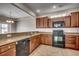 View of kitchen featuring granite counters, dark cabinets, and modern appliances at 504 Lake Shore Dr., Surfside Beach, SC 29575