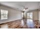 Bright living room with hardwood floors, neutral walls, fan, and sliding glass door at 504 Lake Shore Dr., Surfside Beach, SC 29575