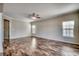 Spacious living room with hardwood floors, neutral walls, fan, and natural light at 504 Lake Shore Dr., Surfside Beach, SC 29575
