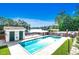 Community pool by a lake with seating area and lush landscaping at 504 Lake Shore Dr., Surfside Beach, SC 29575
