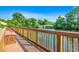 Wooden walkway featuring railing with water views, providing serene access to the waterfront at 504 Lake Shore Dr., Surfside Beach, SC 29575