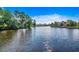 Scenic view of calm waters surrounded by lush greenery, showcasing the property's serene waterfront location at 504 Lake Shore Dr., Surfside Beach, SC 29575