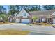 Inviting brick townhome featuring a two-car garage and manicured landscaping for exceptional curb appeal at 5042 Forsythia Circle # 5042, Murrells Inlet, SC 29576