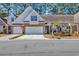 Charming brick townhome with a well-maintained lawn and an attached two-car garage, offering convenience at 5042 Forsythia Circle # 5042, Murrells Inlet, SC 29576