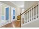 Bright hallway leading to multiple rooms with hardwood floors and white trim at 5042 Forsythia Circle # 5042, Murrells Inlet, SC 29576