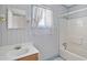 Cozy bathroom featuring blue accents, a window, a classic mirror, and a tub at 5092 Harrelson Ave., Loris, SC 29569