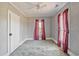 Spacious bedroom featuring a ceiling fan, natural light, and vintage decor elements at 5092 Harrelson Ave., Loris, SC 29569