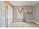 Bedroom with ample closet space, natural light, and vintage wall paneling at 5092 Harrelson Ave., Loris, SC 29569