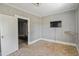 A bedroom with a TV, wallpaper and a view into a closet at 5092 Harrelson Ave., Loris, SC 29569