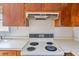 A kitchen stove with overhead exhaust and wood cabinets at 5092 Harrelson Ave., Loris, SC 29569