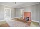Open living room featuring a brick fireplace, light colored walls, and doorway views at 5092 Harrelson Ave., Loris, SC 29569