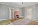 Bright living room with a brick fireplace and multiple doorways offering versatile access at 5092 Harrelson Ave., Loris, SC 29569