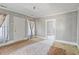 Sunlit living room featuring two windows, a door, and an open doorway to another room at 5092 Harrelson Ave., Loris, SC 29569