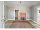 Spacious living room with a brick fireplace, neutral walls, and access to other rooms at 5092 Harrelson Ave., Loris, SC 29569