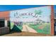 Large and vibrant mural of Loris, S.C. that depicts its history with a tractor and a farm at 5092 Harrelson Ave., Loris, SC 29569