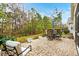 Beautiful patio with an outdoor dining set perfect for entertaining, surrounded by lush greenery at 518 Heartland Ct., Murrells Inlet, SC 29576