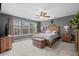 Spacious bedroom with a ceiling fan, a trunk, and large windows allowing lots of natural light at 518 Heartland Ct., Murrells Inlet, SC 29576