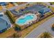 Aerial view of community pool, parking, palm trees and pool house at 518 Heartland Ct., Murrells Inlet, SC 29576