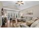 Open living room featuring a vaulted ceiling, fireplace, hardwood flooring, and neutral color palette at 518 Heartland Ct., Murrells Inlet, SC 29576
