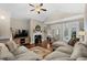 Cozy living room with fireplace, ceiling fan, and french doors to the outdoors at 518 Heartland Ct., Murrells Inlet, SC 29576