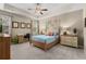 Serene main bedroom with tray ceilings, large windows, and a cozy sitting area at 518 Heartland Ct., Murrells Inlet, SC 29576