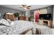 Spacious main bedroom with a ceiling fan, wood furniture, and view to an ensuite bath at 518 Heartland Ct., Murrells Inlet, SC 29576