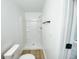 Bright bathroom featuring a modern shower with shelving and hardwood floors at 530 Yarboro St., Mullins, SC 29574