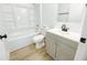 Bright bathroom featuring a tub with shower, gray vanity with white countertop and chrome fixtures at 530 Yarboro St., Mullins, SC 29574