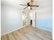 Bedroom with hardwood floors, a ceiling fan, and a view into the en-suite bathroom at 530 Yarboro St., Mullins, SC 29574