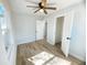Bedroom featuring wood-look flooring, ceiling fan, and doorways to other rooms at 530 Yarboro St., Mullins, SC 29574