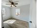 Bedroom with wood-look flooring, ceiling fan, and a view from the dual windows at 530 Yarboro St., Mullins, SC 29574