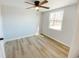 This bright and spacious bedroom has a ceiling fan, new floors and a large window at 530 Yarboro St., Mullins, SC 29574