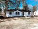 Charming renovated single-story home with a classic black and white exterior design, and tree-lined background at 530 Yarboro St., Mullins, SC 29574