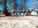 Charming renovated single-story home with a classic black and white exterior design, and tree-lined background at 530 Yarboro St., Mullins, SC 29574