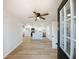 Bright open-concept kitchen with modern white cabinets, a large center island, and stainless steel appliances at 530 Yarboro St., Mullins, SC 29574