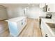 Modern kitchen featuring white cabinets, stainless steel appliances, and light wood flooring at 530 Yarboro St., Mullins, SC 29574