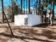 Exterior of a white cinder block storage building surrounded by trees in a wooded area at 530 Yarboro St., Mullins, SC 29574