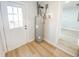 Utility room with hot water heater and access to exterior, neutral walls, and light wood-look flooring at 530 Yarboro St., Mullins, SC 29574
