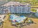 Multi-story condo with uniquely shaped pool and lush landscaping on a sunny day at 5801 Oyster Catcher Dr. # 1614, North Myrtle Beach, SC 29582