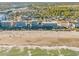 Aerial image of the beach with condo buildings and ocean waves on a sunny day at 5801 Oyster Catcher Dr. # 1614, North Myrtle Beach, SC 29582
