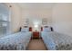 Comfortable bedroom featuring twin beds with matching quilts and bedside lamps at 5801 Oyster Catcher Dr. # 1614, North Myrtle Beach, SC 29582