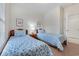 Cozy bedroom featuring two twin beds with blue floral comforters and simple decor at 5801 Oyster Catcher Dr. # 1614, North Myrtle Beach, SC 29582