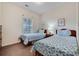 Bright bedroom with two twin beds, complemented by natural light and simple wall art at 5801 Oyster Catcher Dr. # 1614, North Myrtle Beach, SC 29582